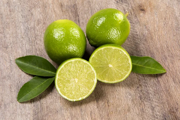 Fresh citrus lime with mint close up on wooden background