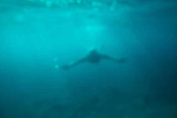 Man swim underwater sea abstract background