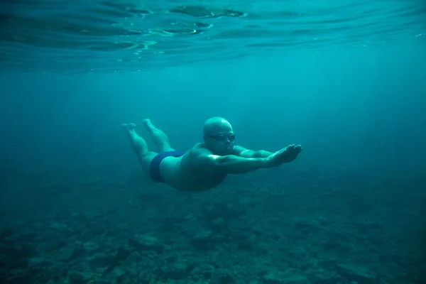 Man swim underwater sea