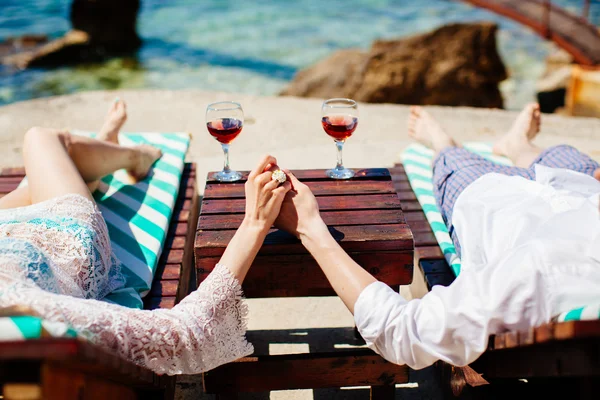 Honeymoon couple relax on beach with sea view