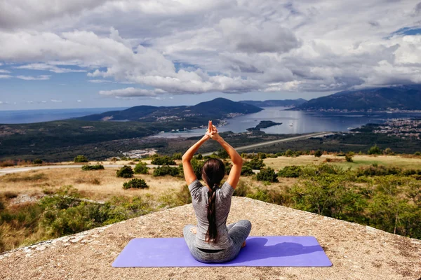 Woman yoga relaxation in serene landscape