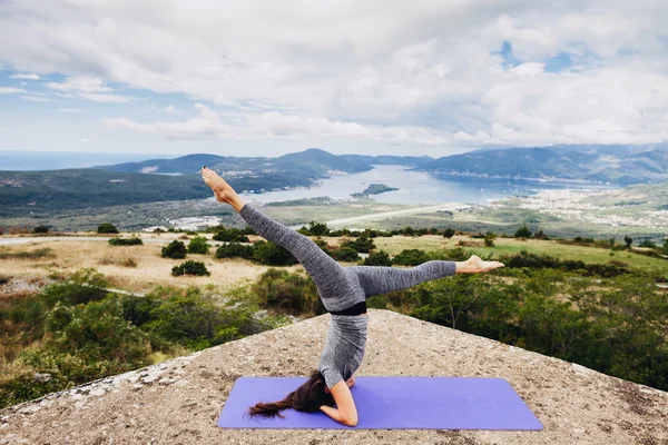 Woman yoga relaxation in tranquil landscape