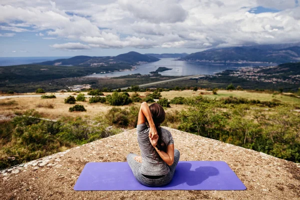 Woman yoga relaxation in serene landscape