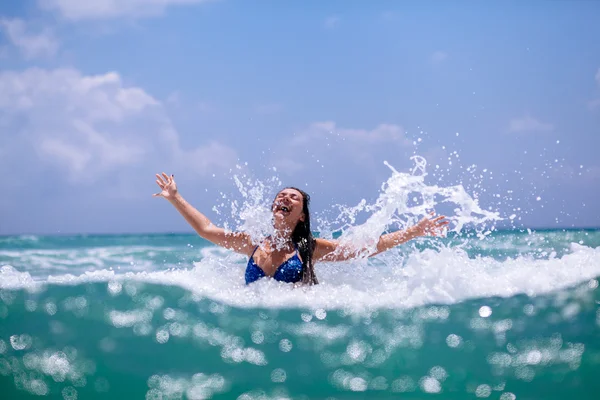 Happy girl sea waves splash