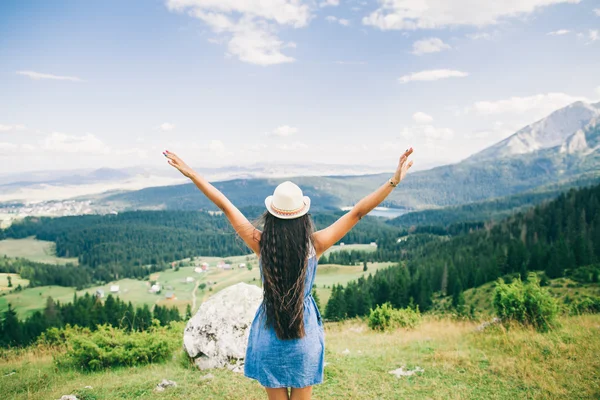 Long hair woman travel in mountains landscape back view