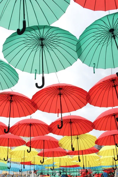 A lot of multicolored umbrellas. Color umbrellas urban decoration