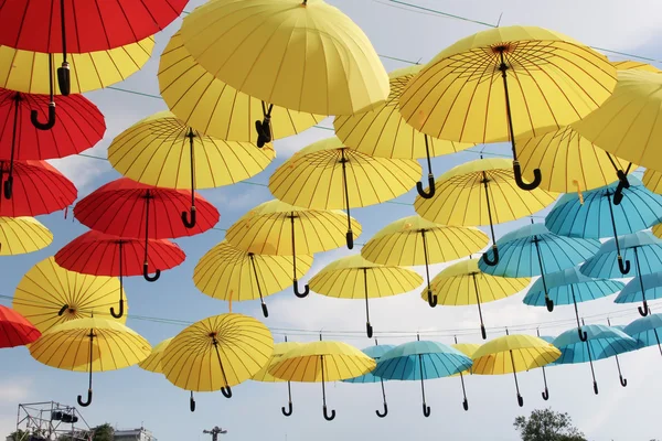 A lot of multicolored umbrellas. Color umbrellas urban decoration