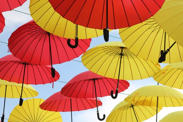 A lot of multicolored umbrellas. Color umbrellas urban decoration