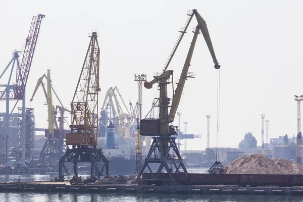 Odessa, Ukraine - July 26, 2015: Cargo cranes on rails and cargo