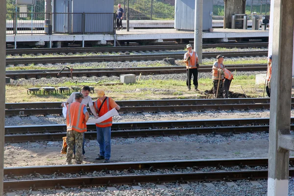 Railway workers conduct repair