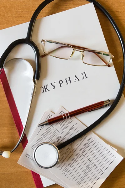 Medical Journal, Pen, stethoscope, glasses and medical certifica