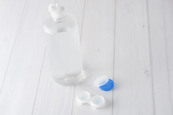 Contact lenses case and solution on white background