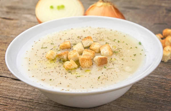 French onion soup on wooden table