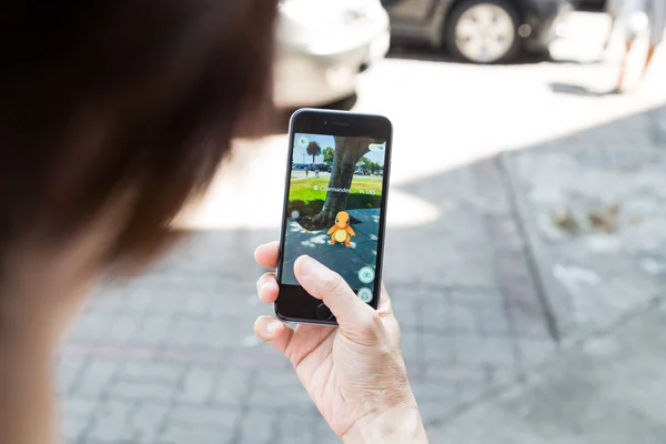 KUALA LUMPUR, MALAYSIA, JULY 16, 2016: An IOS user plays Pokemon Go, a free-to-play augmented reality mobile game developed by Niantic for iOS and Android devices.