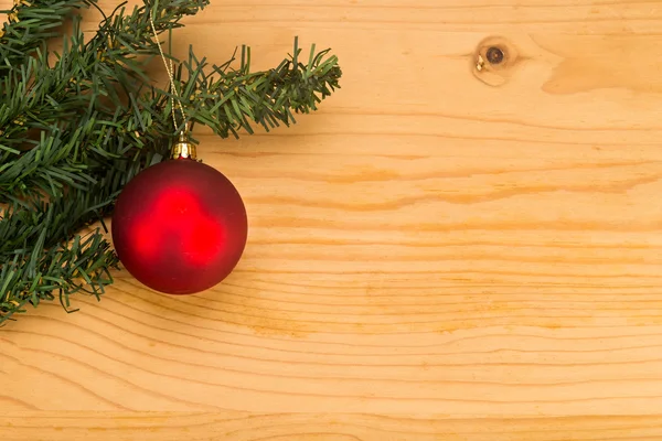 Simple wooden Christmas background with fir tree and ornaments.