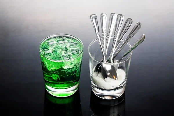 Concept of green fizzy drinks with unhealthy sugar content