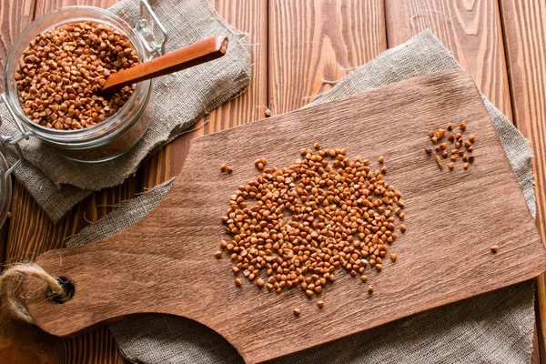 Good or bad buckwheat groats on a cutting board