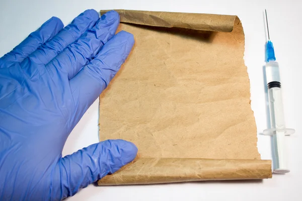 The sheet of paper in hands in medical gloves