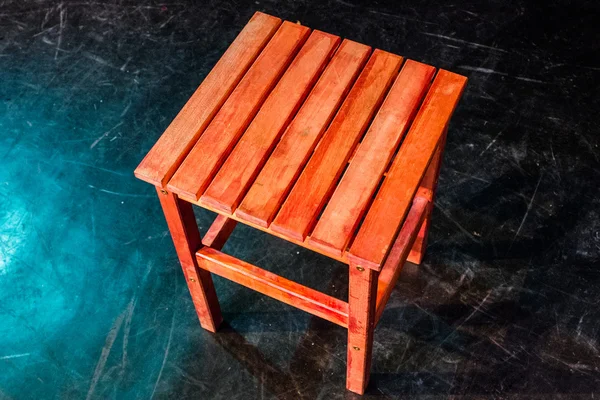 Wooden step stool over black