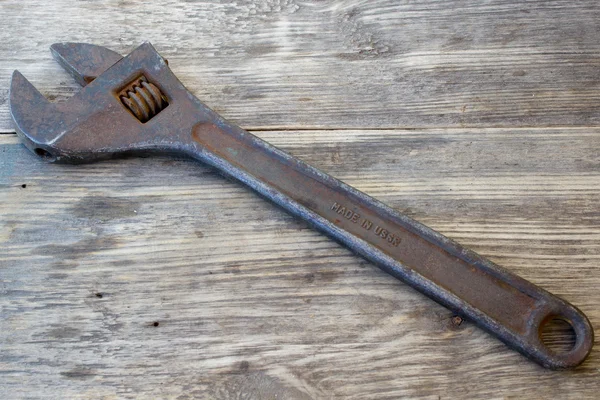 Old vintage retro used open-end wrenches on wooden table, rusty wrench Soviet-made