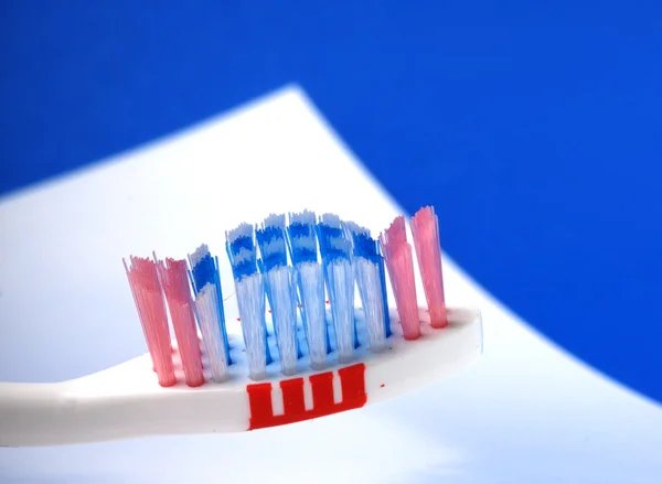 Close-up of blue abd green tooth brushes