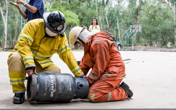 Fireman wearing his uniform with gas tank on fire training