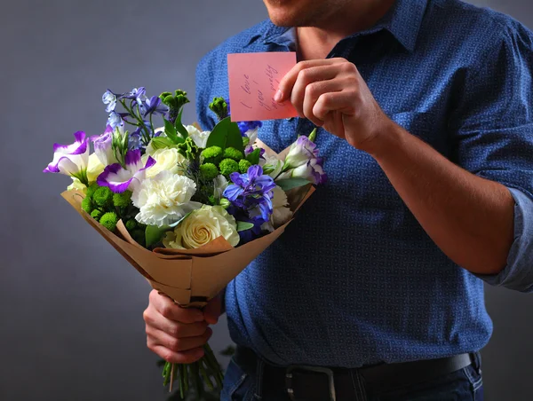 A man with a blue bouquet