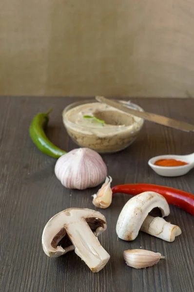 Fresh chicken pate with vegetables and herbs on a wooden choppin