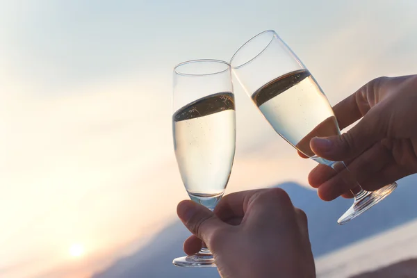 Toast at sunset with white wine flute