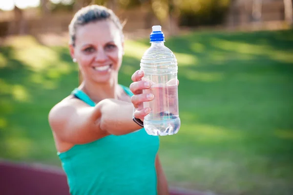 Female athlete holding a water bottle