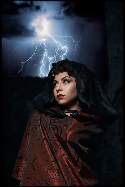 Dark queen of the ghost in a dark castle collapsed, causing lightning zipper magic hands visible destruction of the castle wall and the lightning zipper in the sky