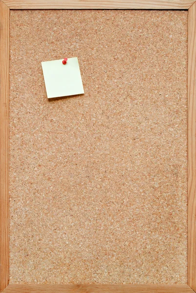 Bulletin board with a post it note