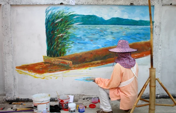 Artist painting on wall