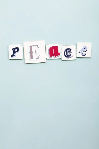 Peace signboard. Handwritten colors letters word. Light blue backgrou