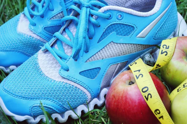 Sneakers, centimeter, red apples, weight loss, running, healthy eating, healthy lifestyle concep