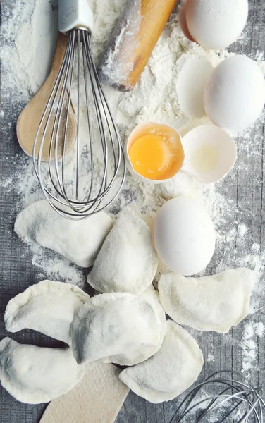 Still life with raw homemade pasta and ingredients for pasta..process of cooking pasta.the process of making homemade dumplings,delicious lunch