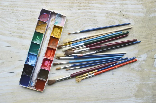 Painting, paint, brushes for painting, landscape paper, creativity on the wooden background