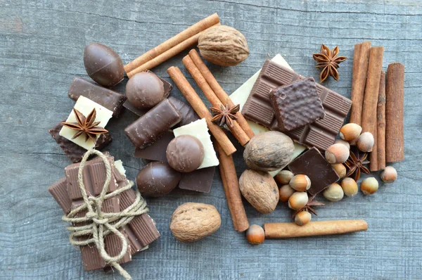 Various pieces of chocolate and cinnamon with nuts and anise