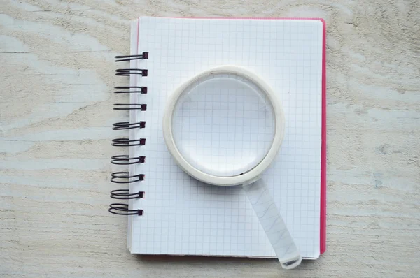 Notebook with magnifying glass