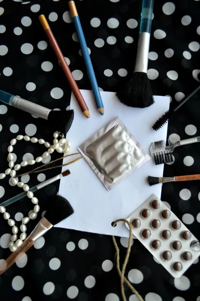 Set of female cosmetics on a white sheet of paper