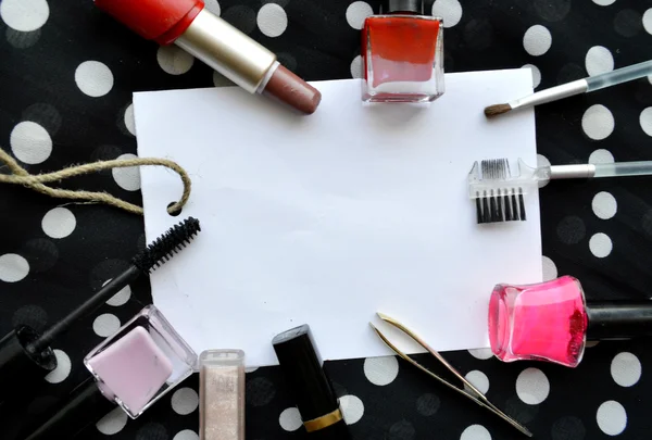Set of female cosmetics on a white sheet of paper