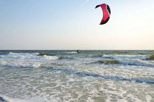 Kiter riding on the waves of the Black Sea