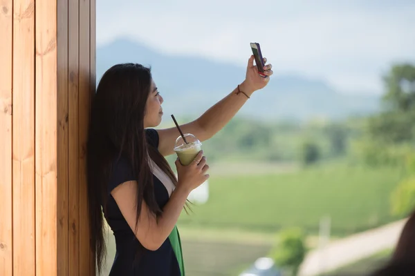 Beautiful asian women hold  cup of ice mocha green tea coffee in