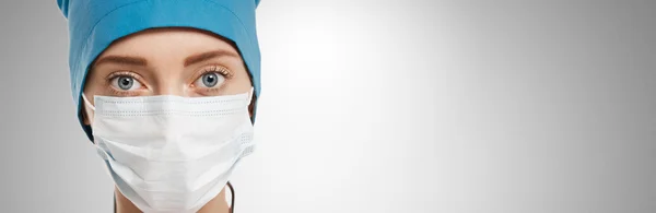 Close-up portrait of female surgeon isolated over background
