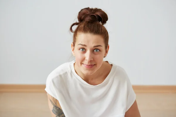 ?ute smiling woman. Closeup portrait woman looking happy. Sitting on the floor and relaxing in the bedroom at the weekend. Positive human emotion facial expression body language. Funny girl