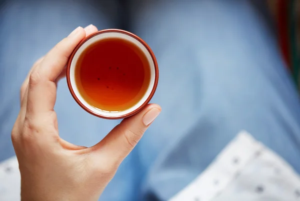 Woman holding hot cup of tea. Female hands holding a mug of hot tea