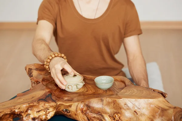 Chinese tea ceremony. Close-up wooden table for the tea ceremony utensils on tea master background at home