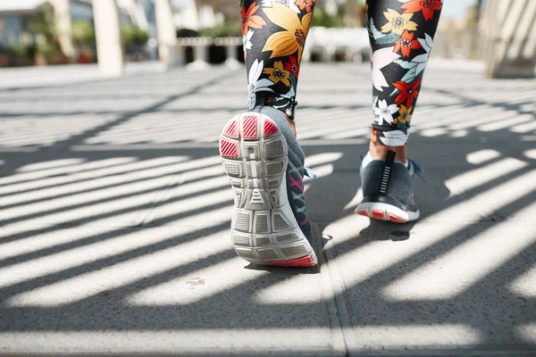 Athlete runner feet running on road closeup on shoe