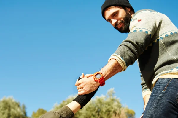 Helping hand - hiking girl get help from a smiling man focus at