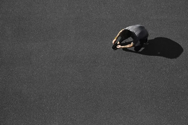 Top view jogging man runner tying running shoes before outdoor w